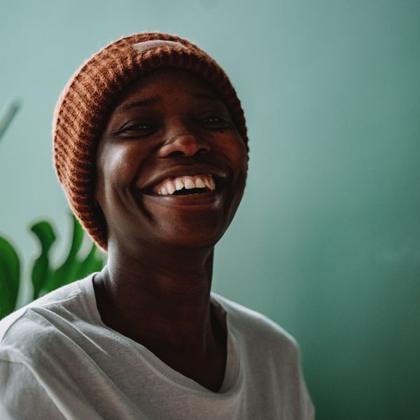 Laughing person in a beanie