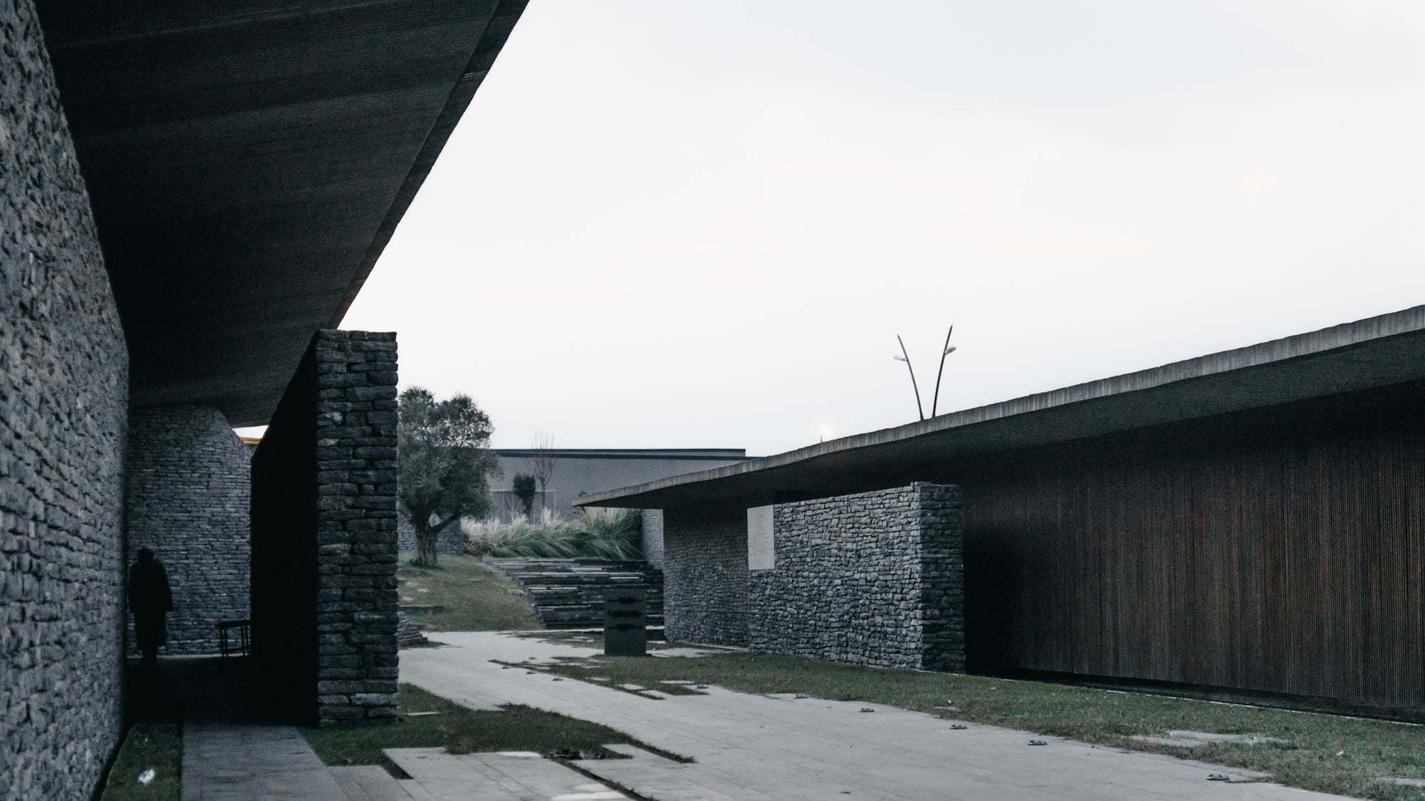 Low stone and timber buildings under a long dark roof