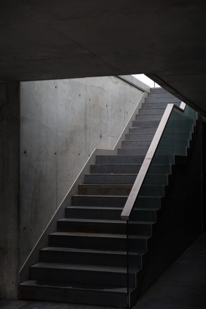 A concrete stair lit from above