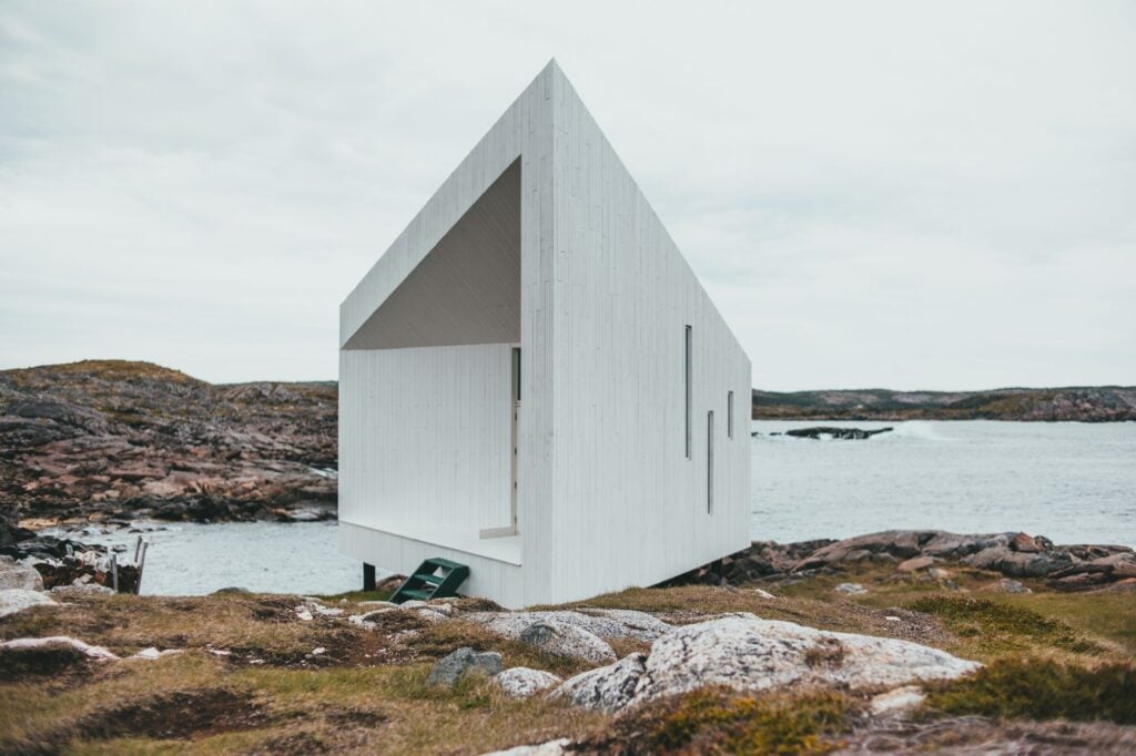 Havhuset, a white angular timber studio on granite rocks by the sea