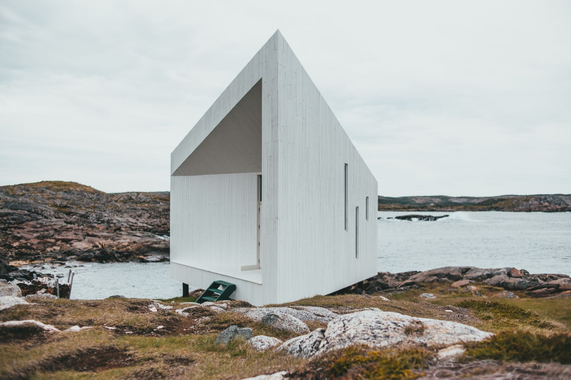 Havhuset, a white angular timber studio on granite rocks by the sea