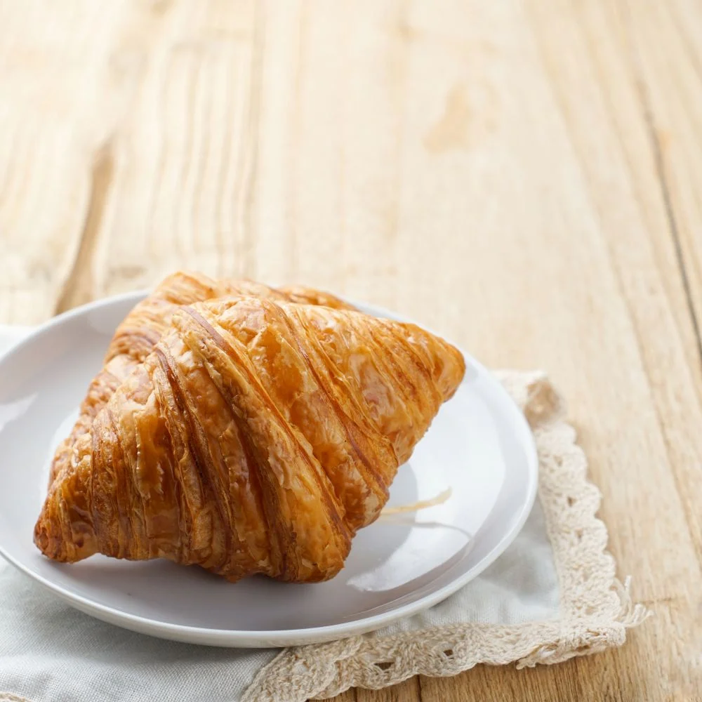 Butter croissant on a white plate
