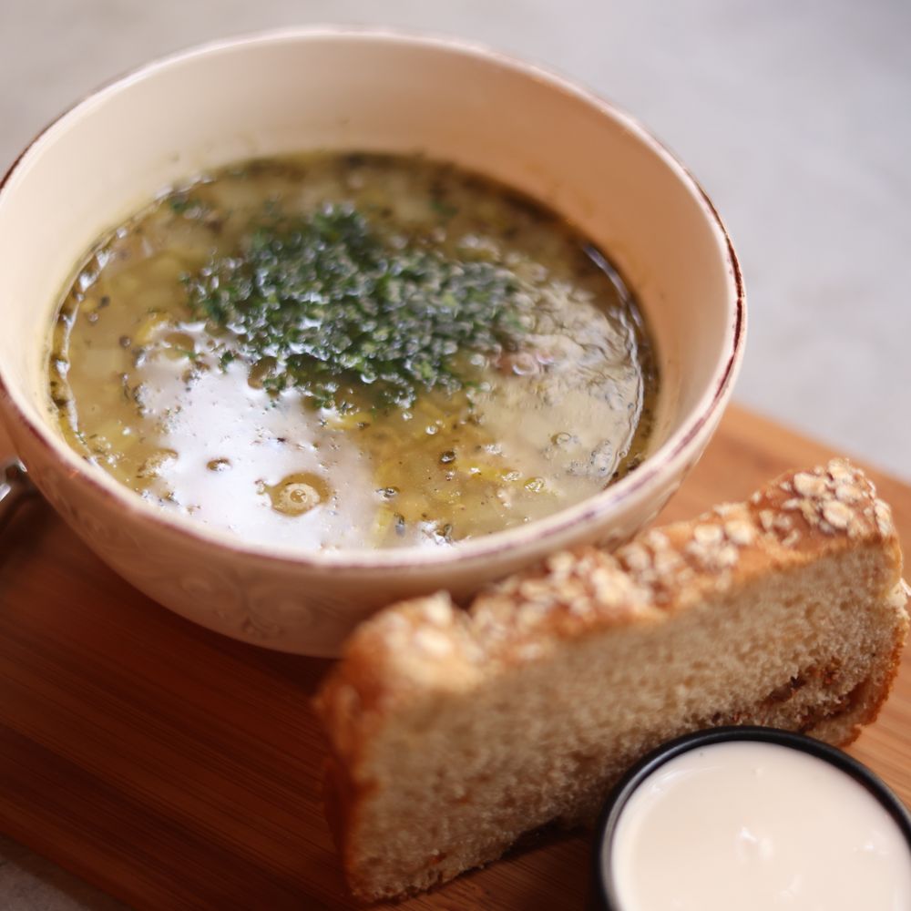 Bowl of soup with a slice of sourdough