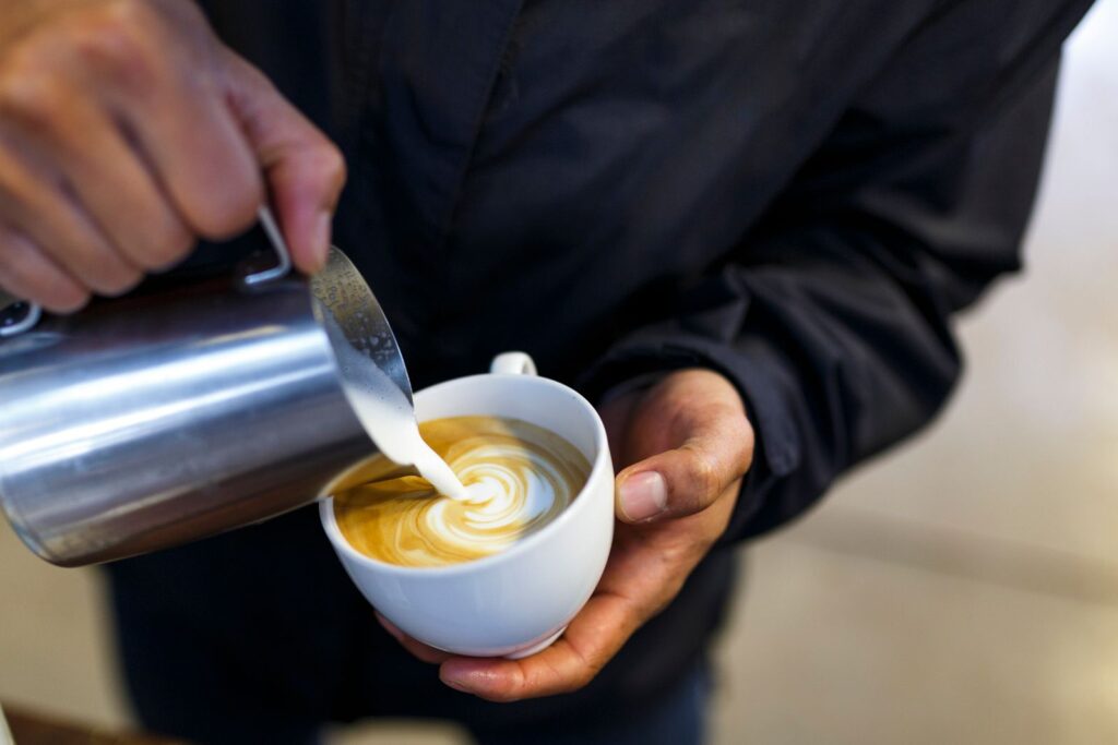 Milk being poured into a latte