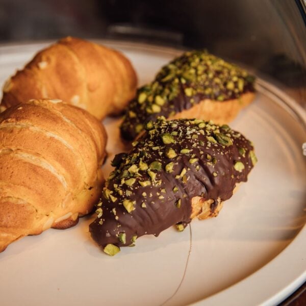 Croissants dipped in chocolate and chopped pistachio