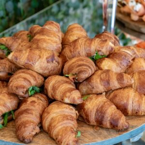 A large platter piled with golden croissants