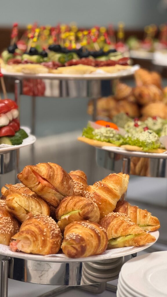A tiered stand of croissants and sandwiches