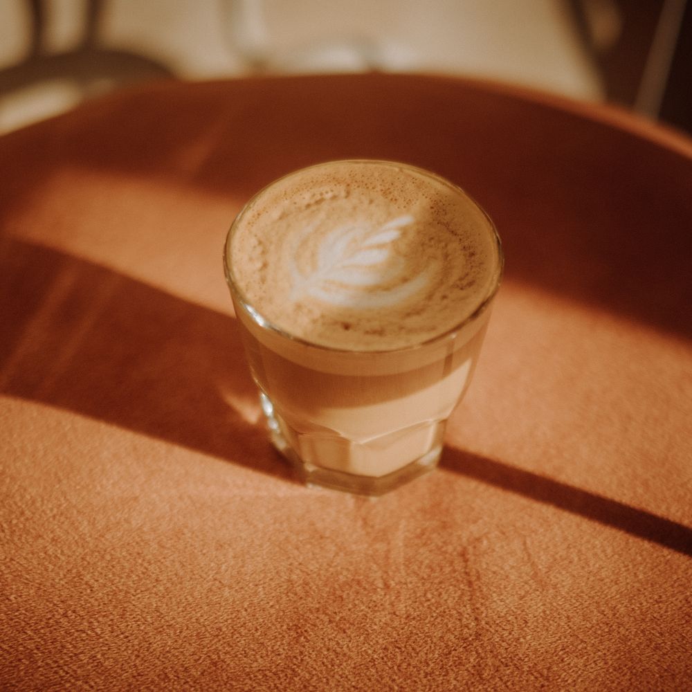 Flat white in a glass in morning sun