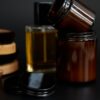 Amber jars of pomade with a bottle of hair tonic and a bar of soap