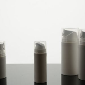Row of grey and white travel-size bottles