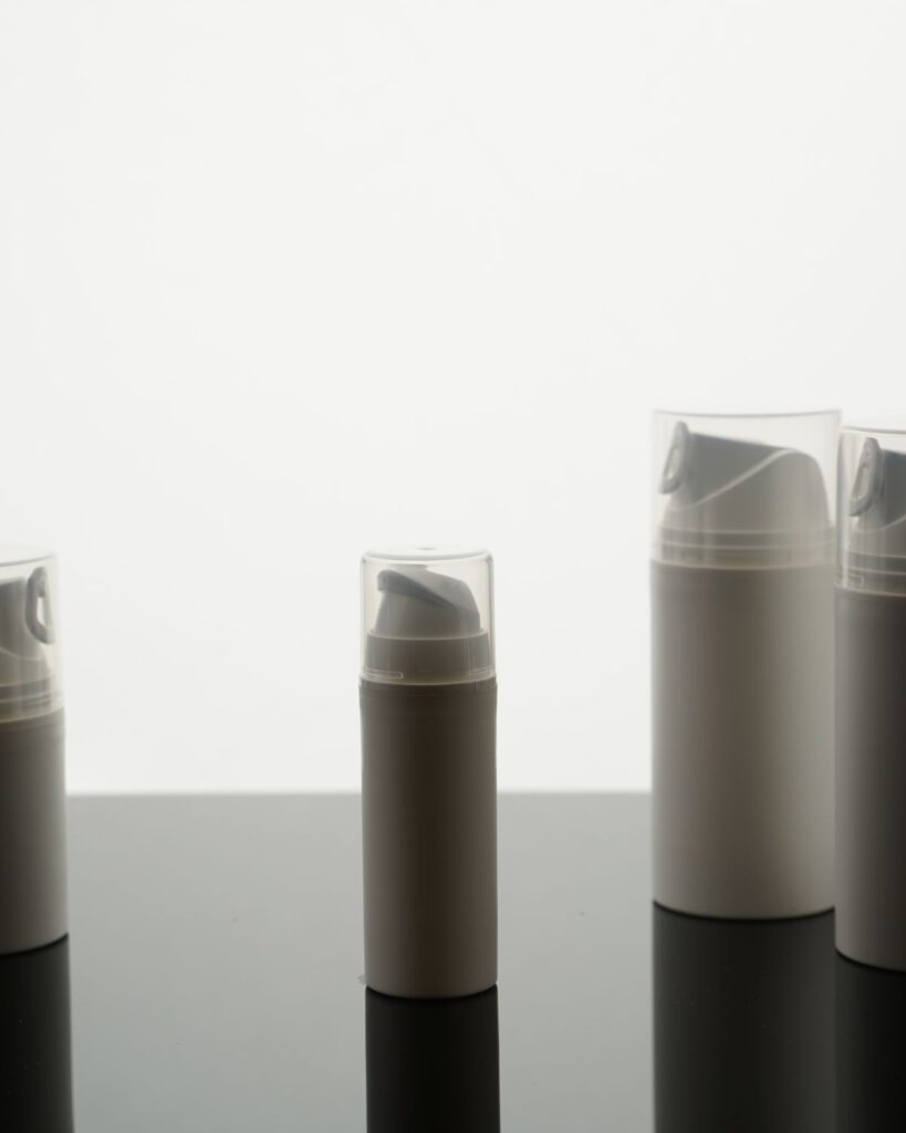 Row of grey and white travel-size bottles