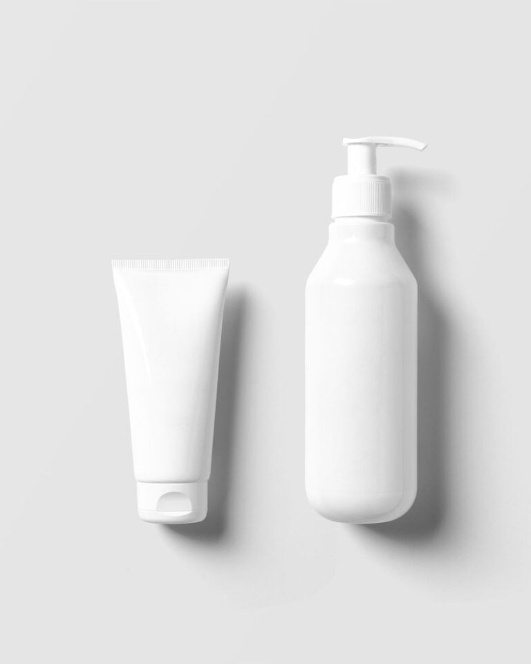 White tube and pump bottle on a white surface