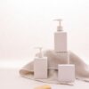 White pump bottles with a folded towel and brush