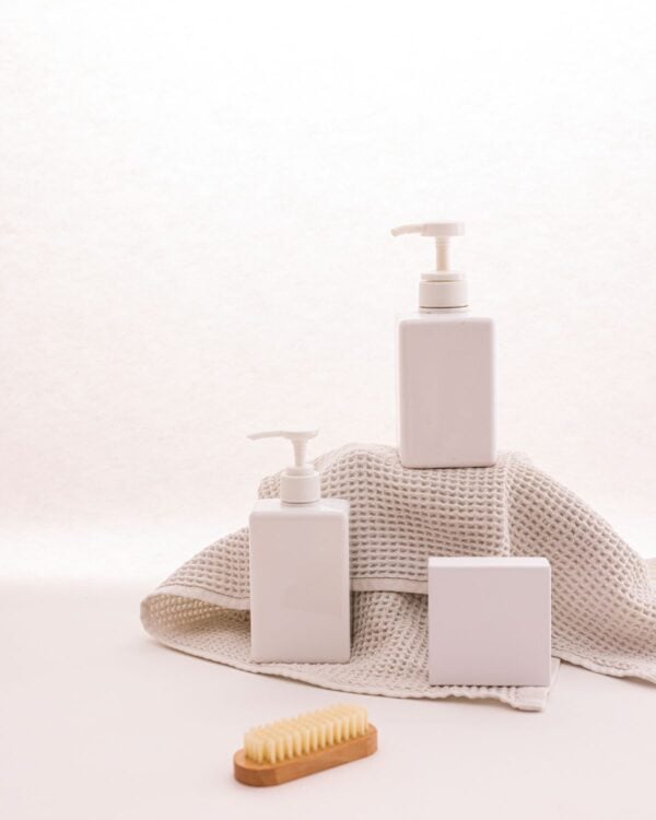 White pump bottles with a folded towel and brush