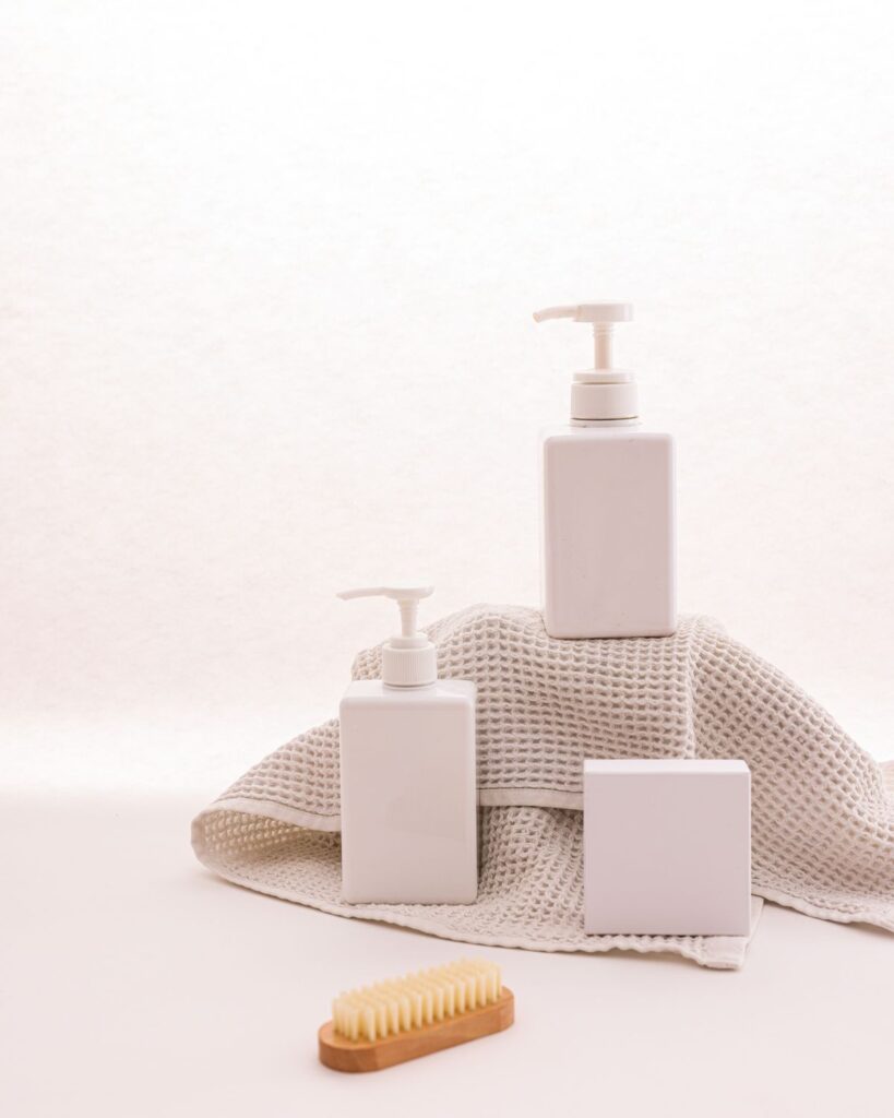 White pump bottles with a folded towel and brush