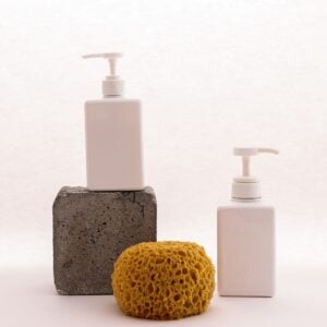 White pump bottles with a stone and sea sponge