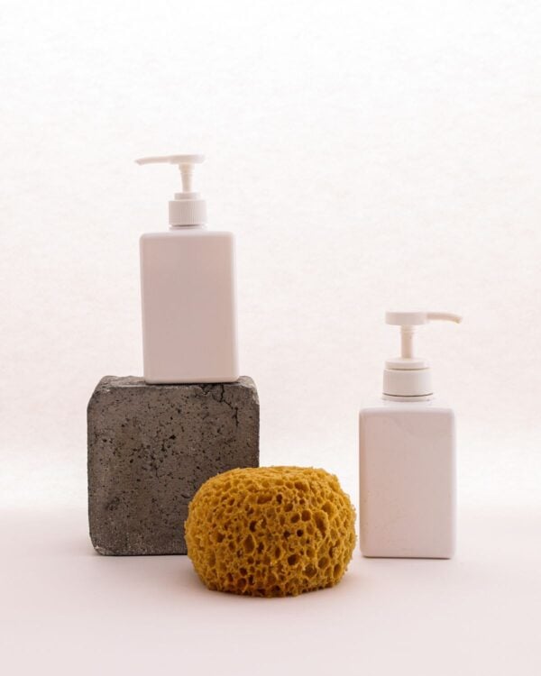 White pump bottles with a stone and sea sponge