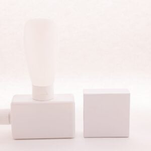 White dispenser bottle beside pale square blocks