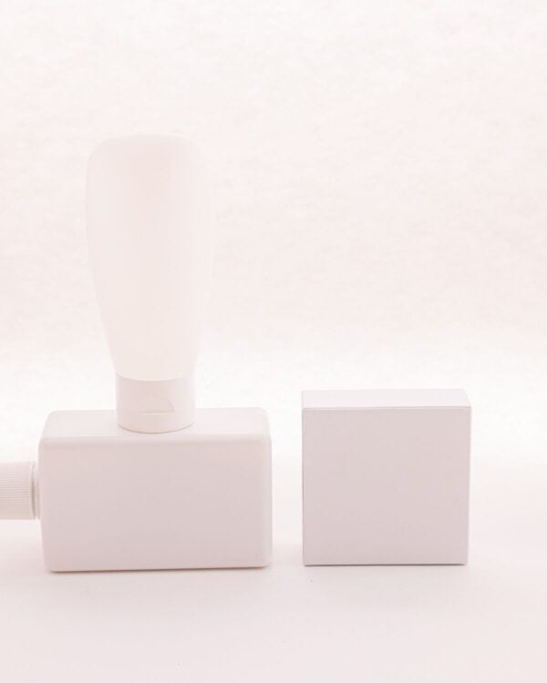 White dispenser bottle beside pale square blocks
