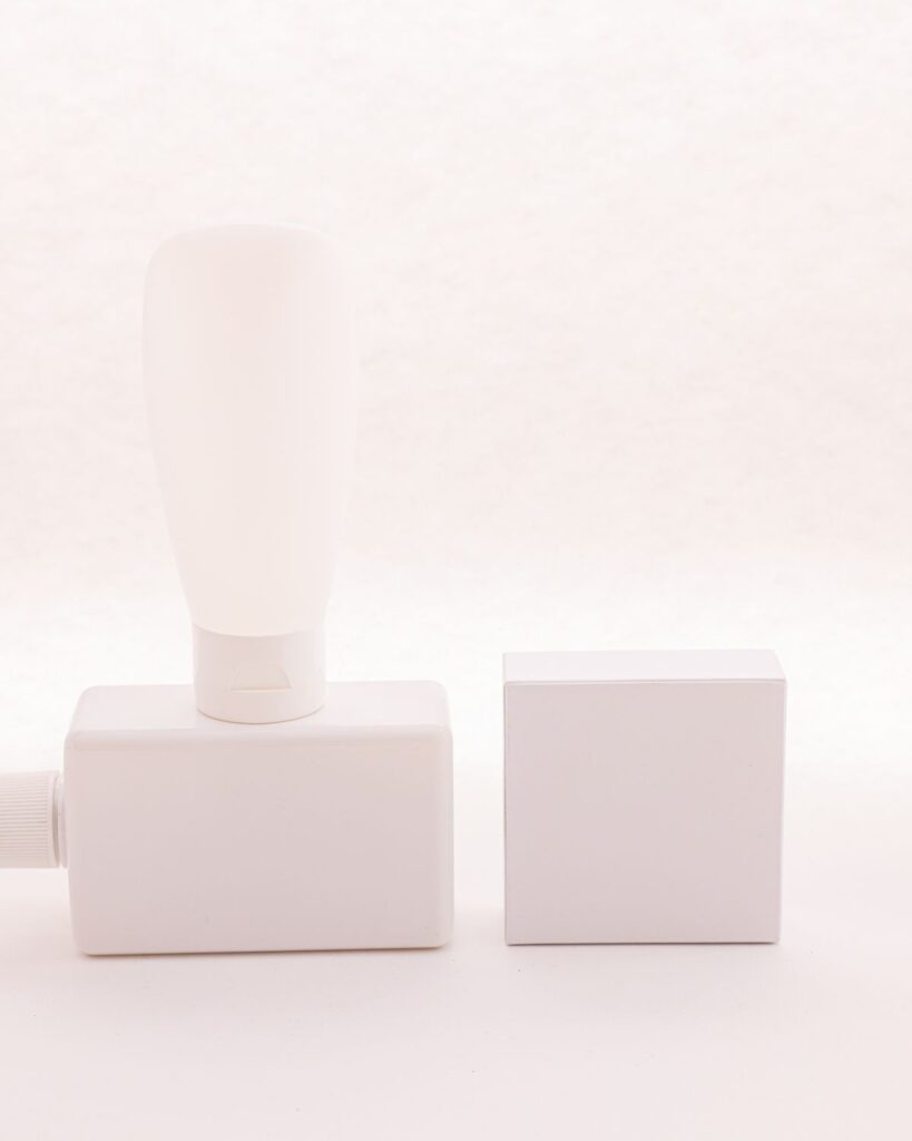 White dispenser bottle beside pale square blocks