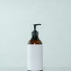 Amber pump bottle with a white label on a pale background