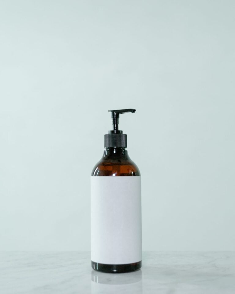 Amber pump bottle with a white label on a pale background