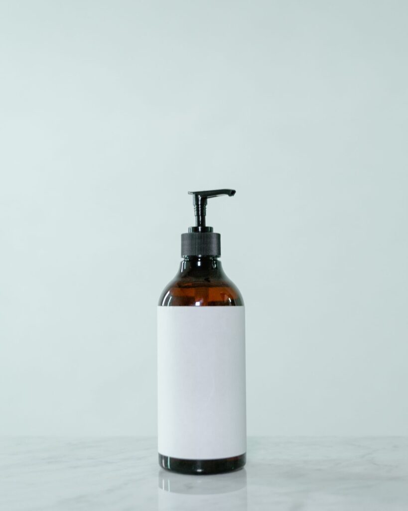 Amber pump bottle with a white label on a pale background