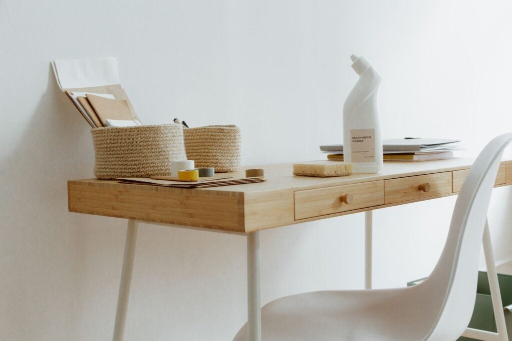 Compact oak writing desk in a white room