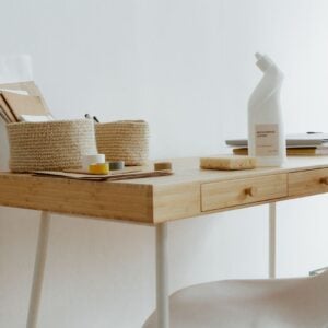 Compact oak writing desk in a white room