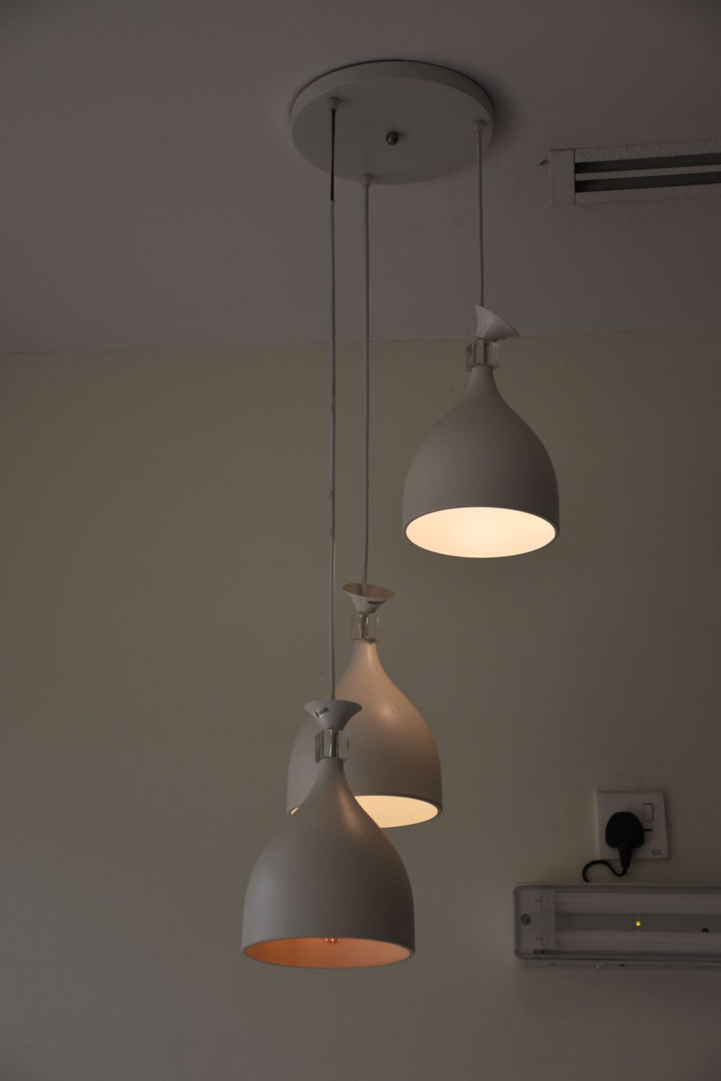 White pendant lamp against a grey wall