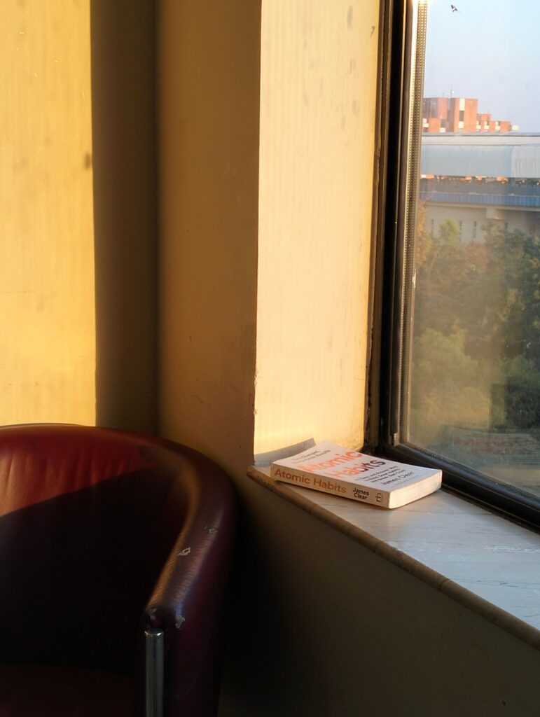 Books on a windowsill in golden light