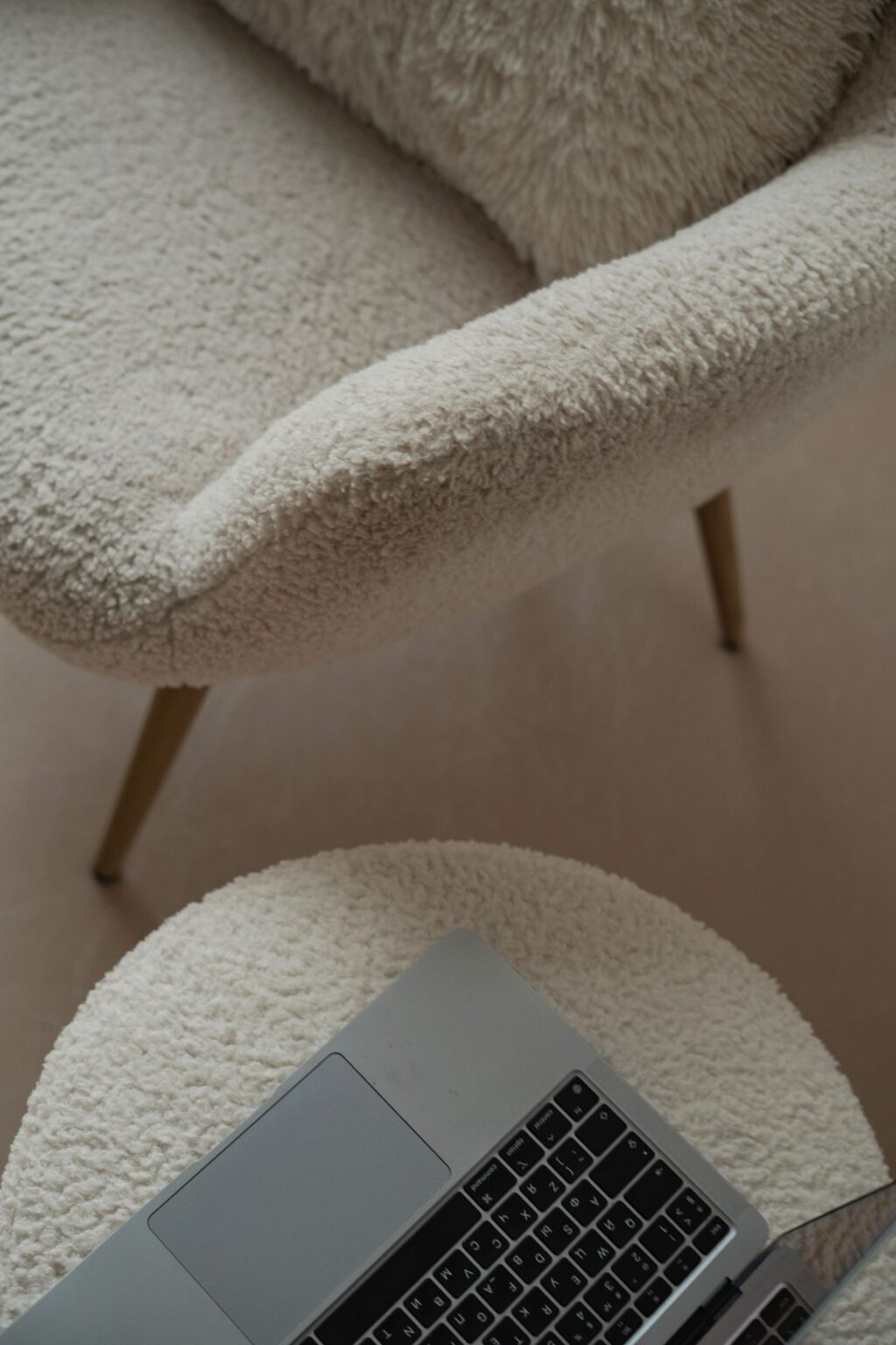 Close-up of the boucle weave and tapered oak leg