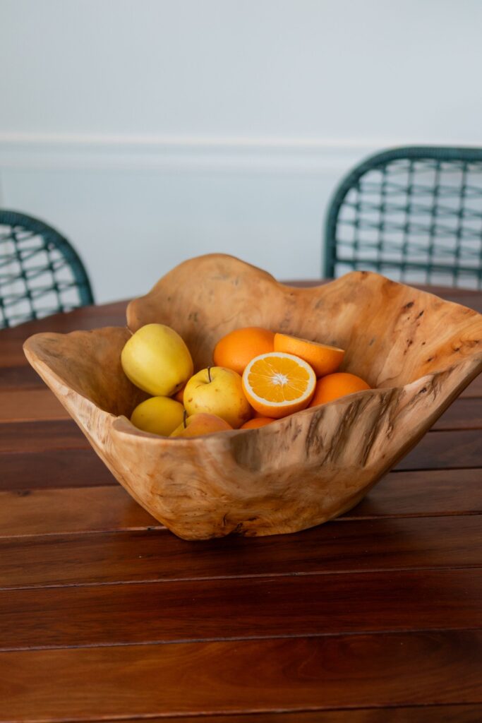 Oiled table top with a wooden fruit bowl