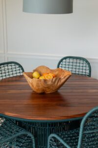 Solid wood dining table with a fruit bowl