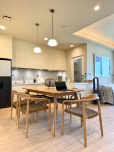 Solid oak dining table with six chairs in an open kitchen