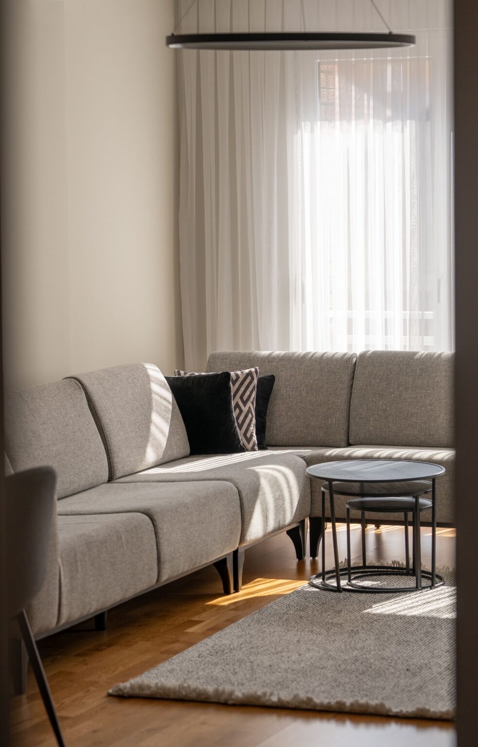 Grey sectional corner sofa with nesting side tables