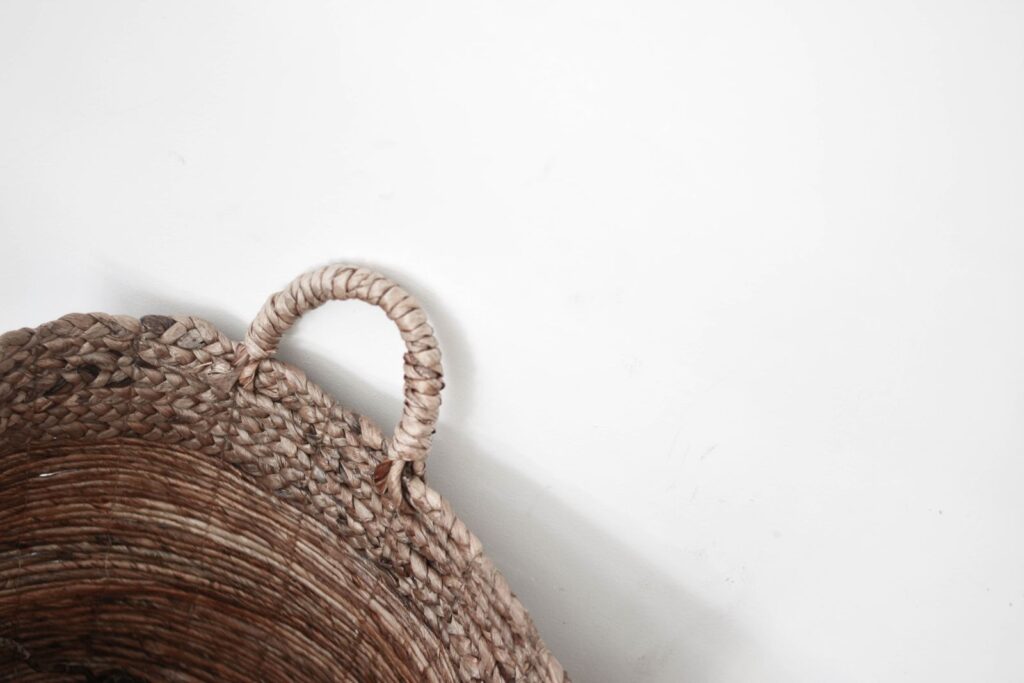 Woven jute storage basket on a white background