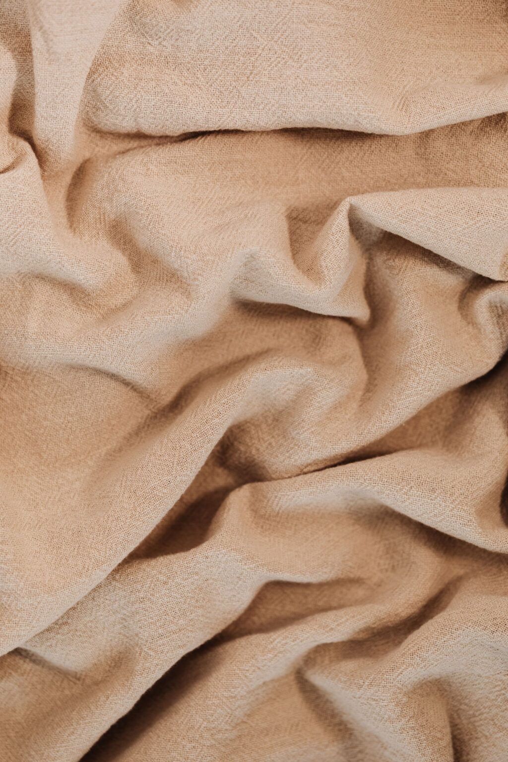 Folds of beige linen fabric