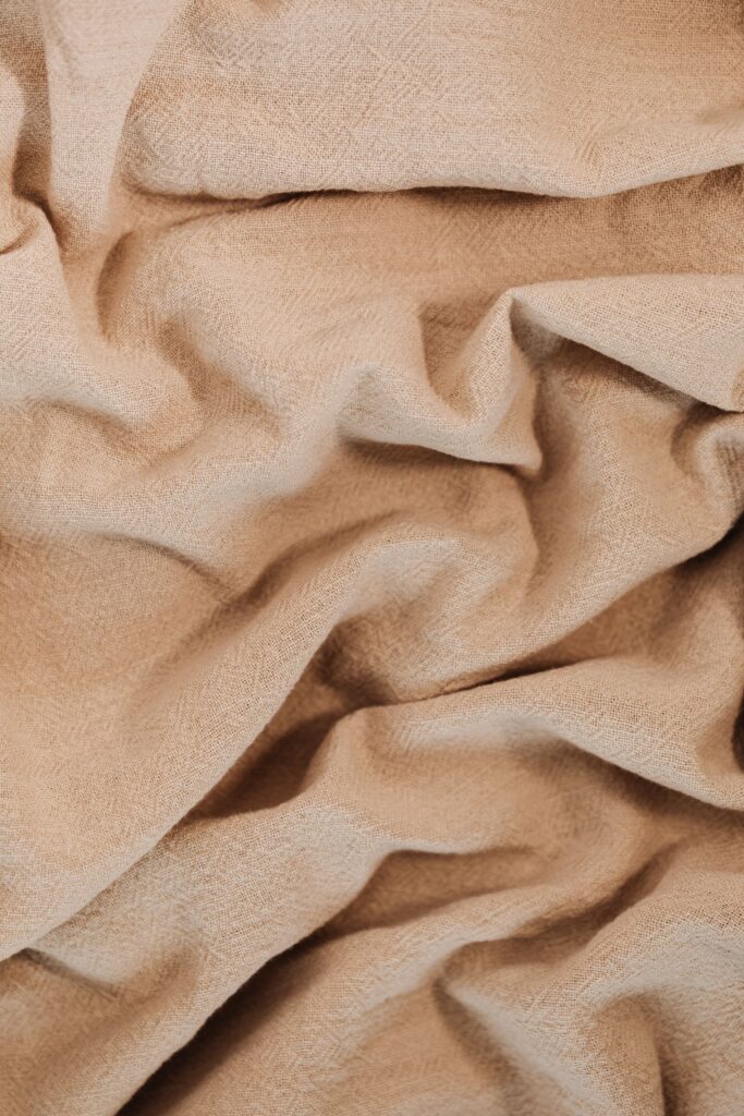 Folds of beige linen fabric