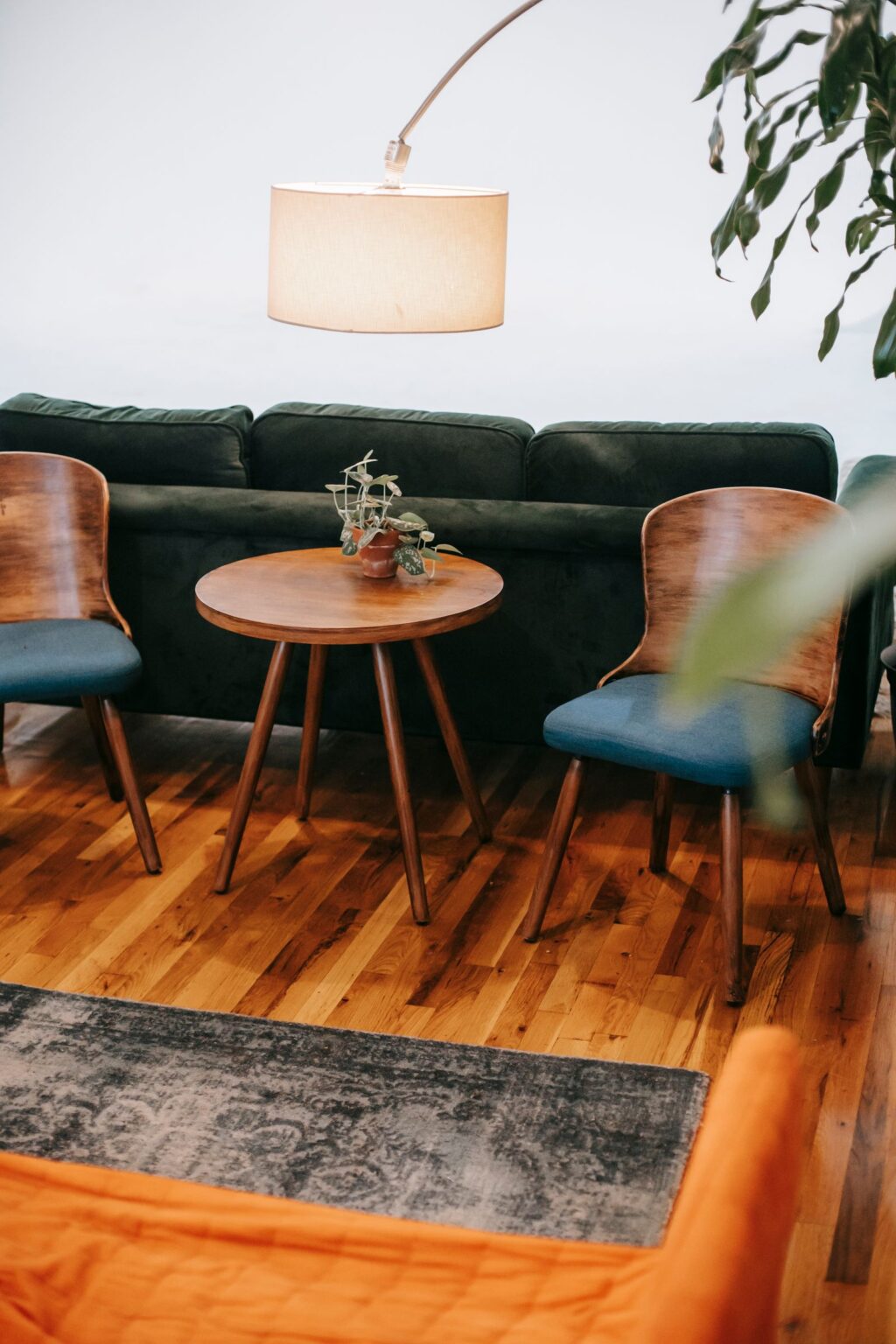 Leather chairs and round table on a white area rug