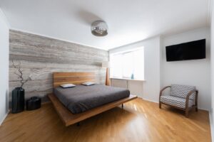 Low oak platform bed in a calm bedroom