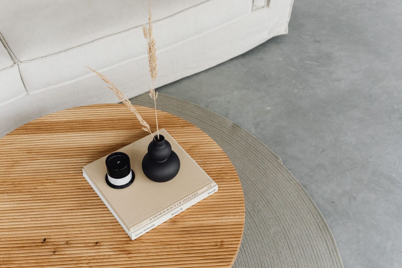 Round coffee table styled with books and a vase