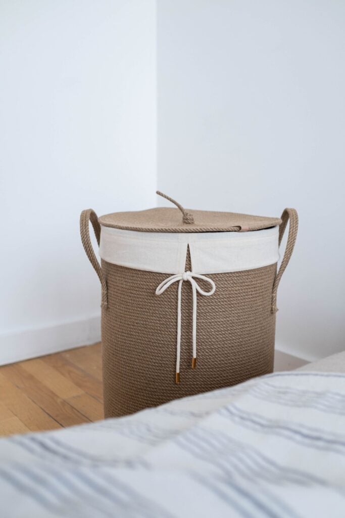 Woven laundry hamper with lid