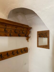 Wooden wall-mounted coat rack with hooks