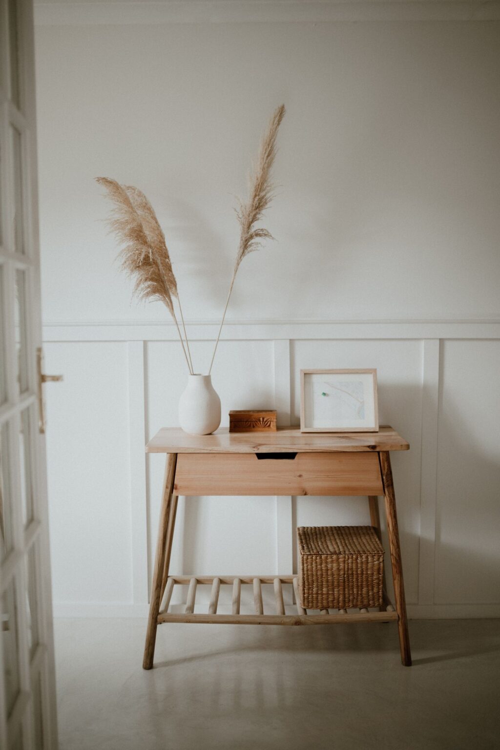 Slim oak console table against a white wall