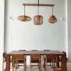 Rattan pendants over a wooden dining table