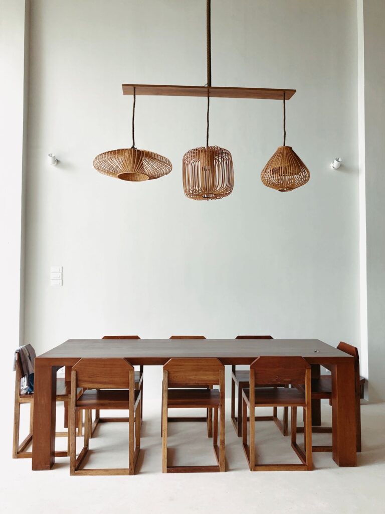 Rattan pendants over a wooden dining table