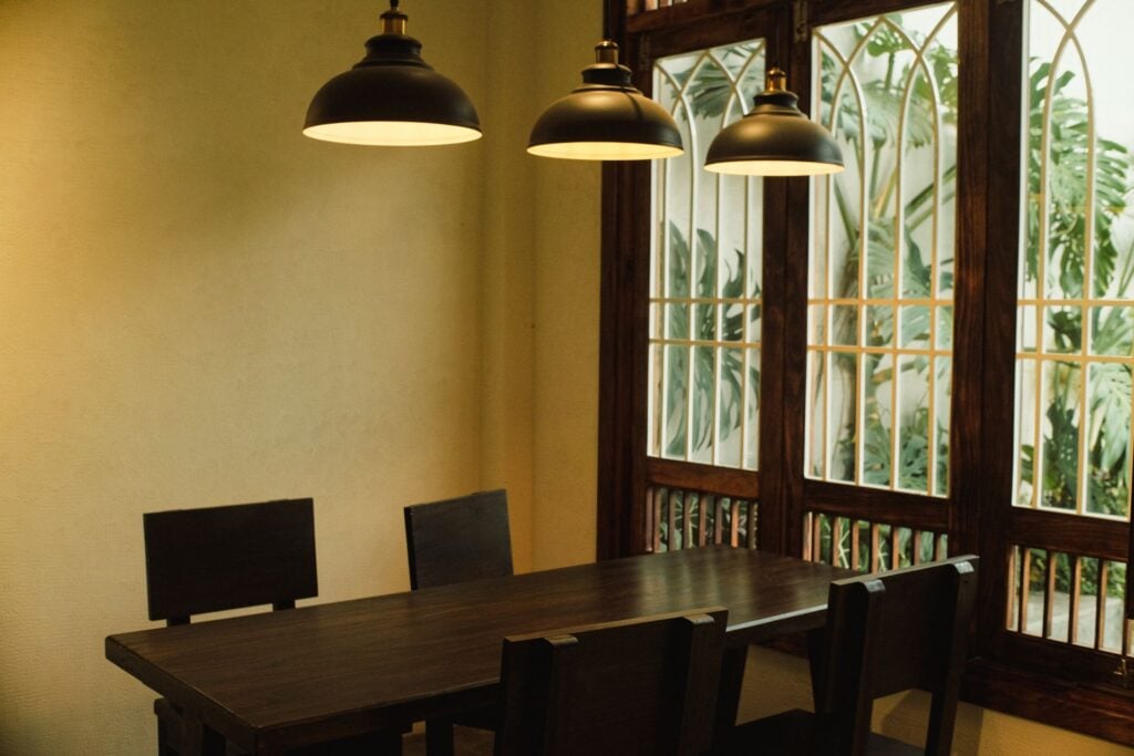 Black dome pendants hanging over a dining table