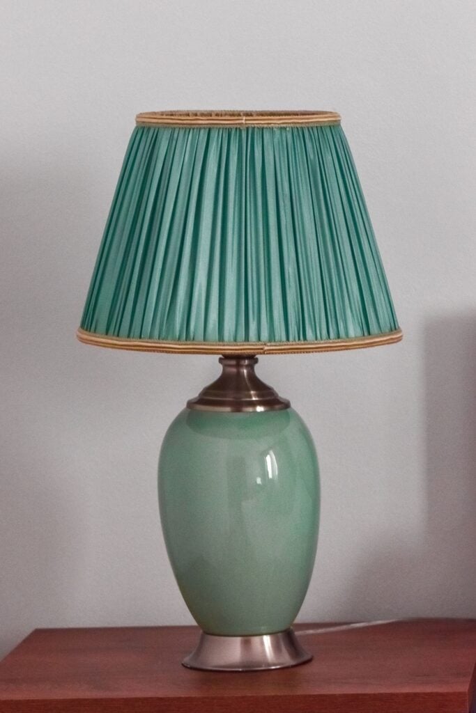 Celadon Lamp with a pleated teal shade on a glazed stoneware base