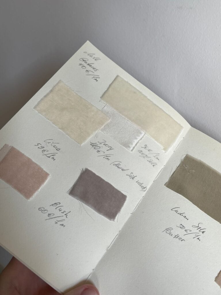 A notebook of linen swatches with handwritten notes